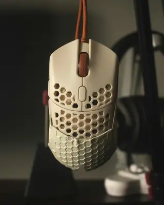 Example of a honeycomb shell gaming mouse showing the weight-reducing perforated design